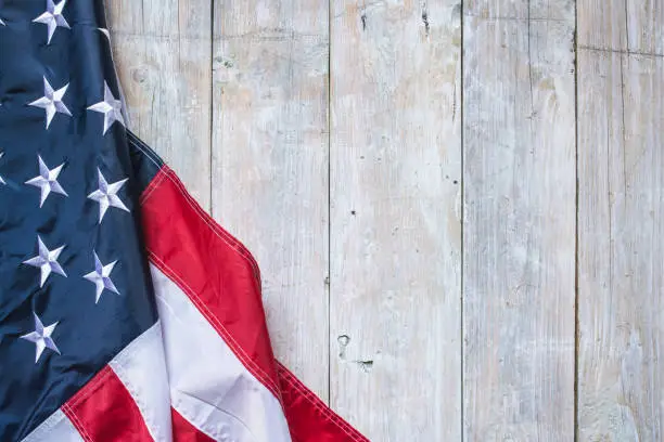 Flag of USA on wooden concrete background.
Empty space provided for text placement for US celebrations such as: Memorial Day, Independence Day, etc.