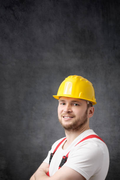 istock Happy, smiling worker with arms crossed looking at camera 1317592591