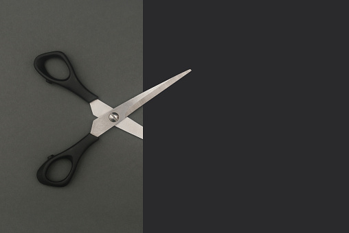 Scissors cutting paper no one holding them, creativity concept.