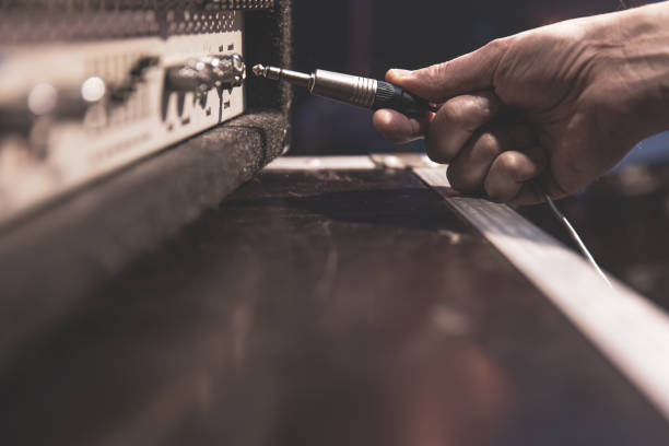 Close up of a connector for connecting audio equipment. Jack audio connector being plugged into a socket on an audio device for music, audio. amplifier plug stock pictures, royalty-free photos & images