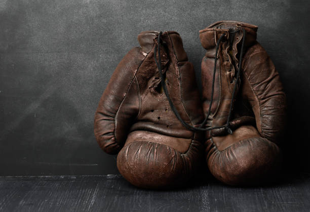 istock brown leather vintage boxing gloves on a black background 1317598653