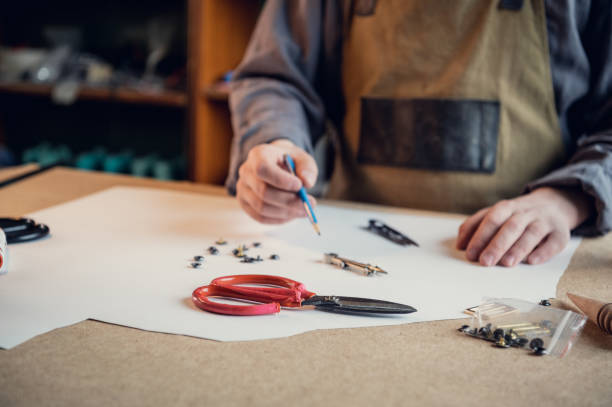 istock Before start working directly with the leather, the shoe manufacturer makes a preliminary pattern out of paper 1317598922