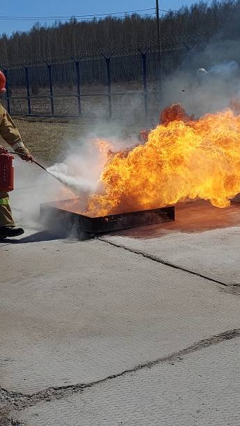 istock a firefighter puts out a fire with a fire extinguisher 1317598932