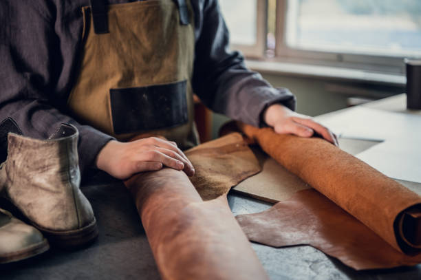istock An experienced tanner at his master class shows how to work with leather, lays it out on the table 1317599256