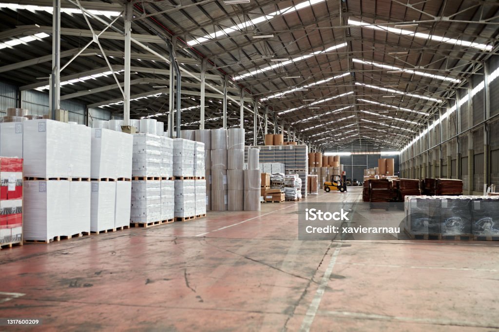 Distribution Warehouse Wide angle view of merchandise stored in large organized warehouse management system. Warehouse Stock Photo
