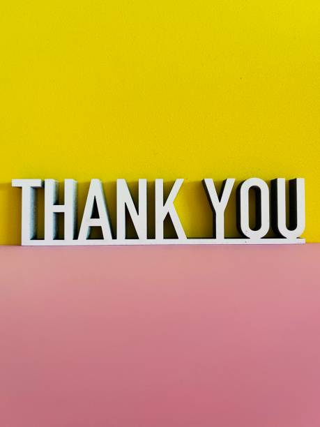 istock Thank you phrase on pink yellow background 1317600445
