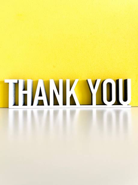 istock Thank you phrase on white yellow background 1317600453