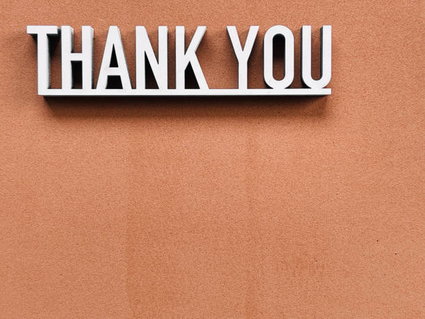 istock Thank you phrase on brown background 1317601267