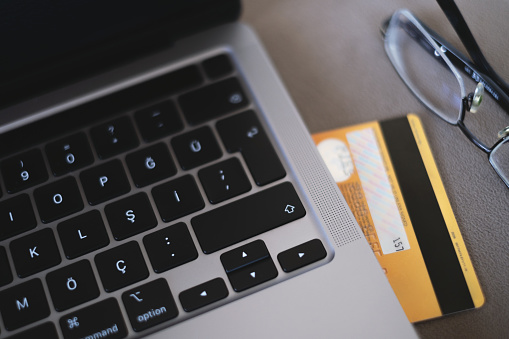 Computer and credit card for online shopping payment.