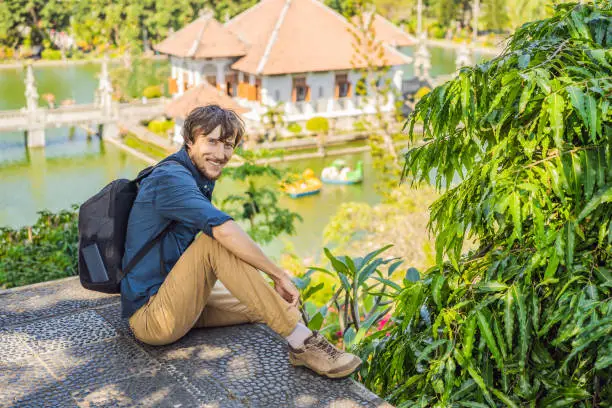 Photo of Dad and son in Water Palace Soekasada Taman Ujung Ruins on Bali Island in Indonesia. Amazing old architecture. Travel and holidays background. Traveling with kids concept. Kids Friendly places