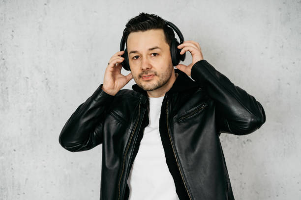 istock Man with wireless headphones wearing a black leather jacket 1317604357