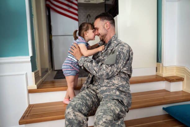 istock Soldier playing with his daughter at home 1317605093