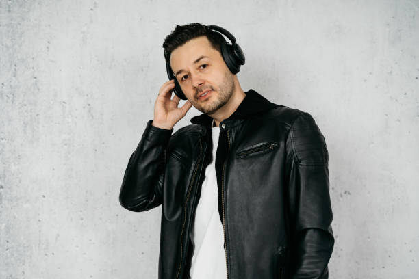 istock Man with wireless headphones wearing a black leather jacket 1317605773