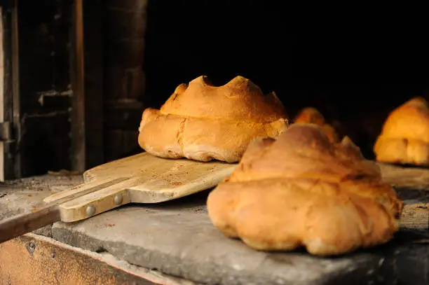 The bread of Matera, Pane di Matera, has the shape of a croissant and is produced with the exclusive use of durum wheat semolina. Matera bread just baked in a wood oven