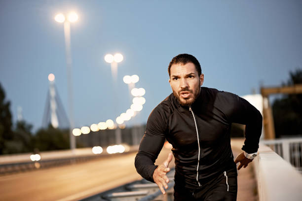 istock A young male athlete, preparing for training at dusk. 1317608273