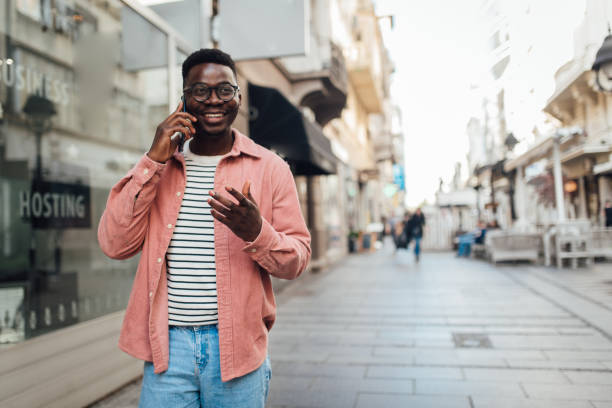 istock Young African American in a walk talking on mobile phone 1317608431