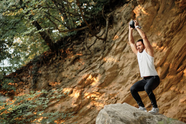 istock A young male athlete is doing exercises with a kettlebell. 1317608513