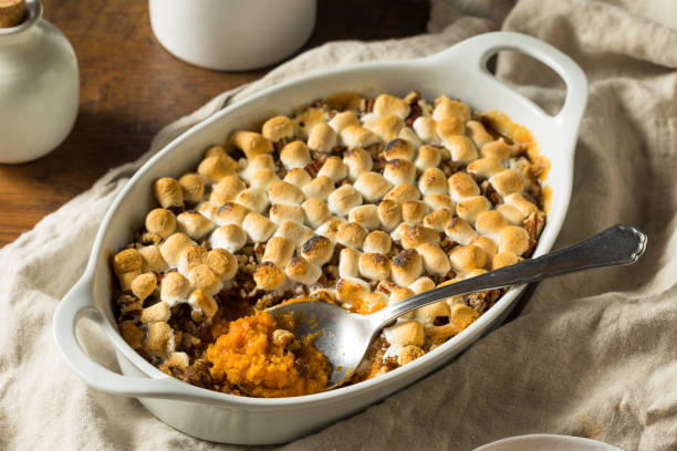 Homemade Sweet Potato Casserole Homemade Sweet Potato Casserole with Pecans and Marshmallows casserole stock pictures, royalty-free photos & images