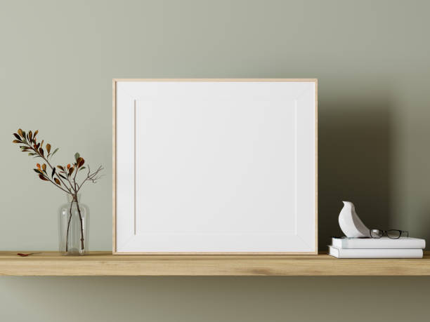 пустой белый макет фоторамки на деревянной полке с зеленым украшением растения - blank frame стоковые фото и изображения