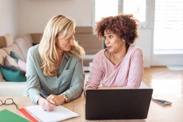 istock Two women sitting at kitchen table and talking 1317609638