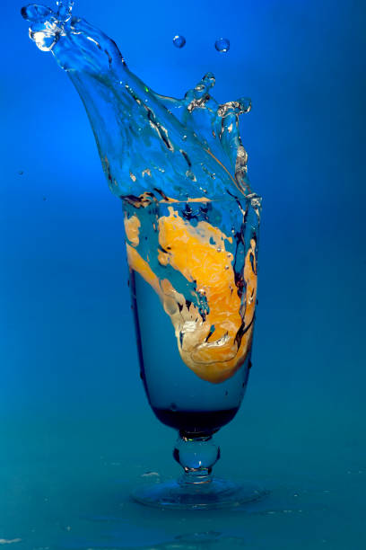 istock liquid splash from fell orange slice in glass 1317609970