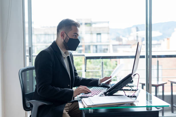 istock Man working in an office on his laptop 1317610491