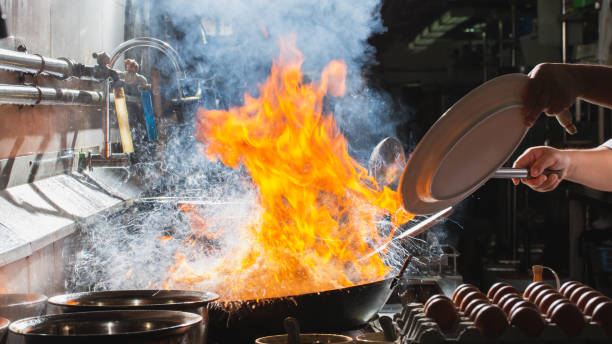 istock Chef stir fry busy cooking in kitchen 1317611105