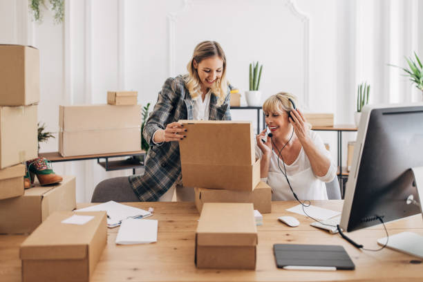 istock Women packing customers online orders 1317612650