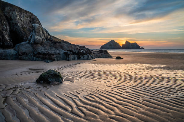 Absolutely beautiful landscape images of Holywell Bay beach in Cornwall UK during golden hojur sunset in Spring stock photo