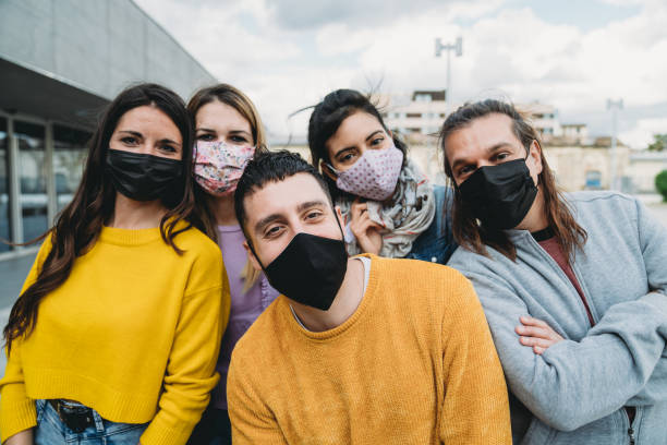 istock Five millennial friends are looking at camera and smiling 1317614629
