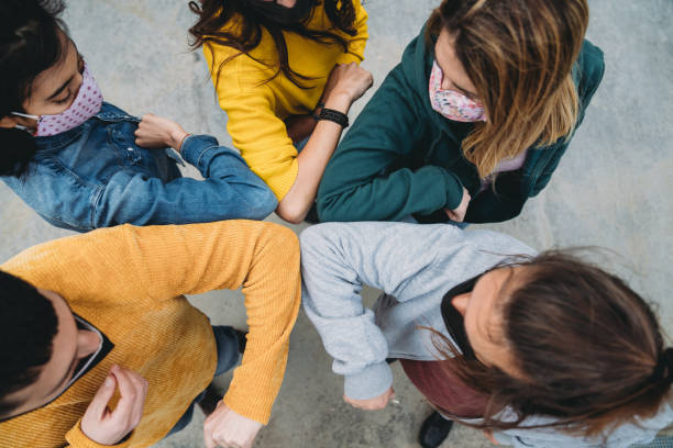 istock Five friends are greeting with an elbow bump all together 1317614807