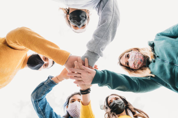 istock Millennial friends stacking hands together - View from below 1317614817