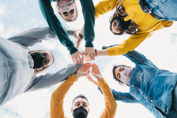istock Millennial friends stacking hands together - View from below 1317614856