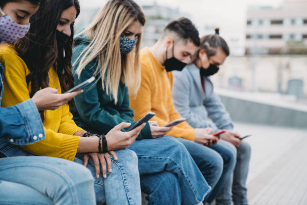 istock Side view of people using smart phones against a wall 1317615018