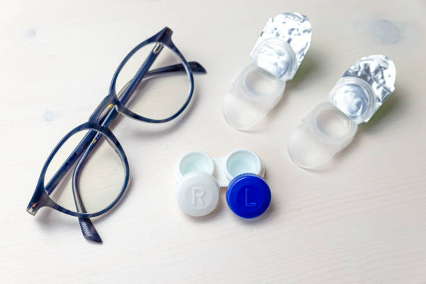 istock Contact lenses and glasses on a white surface. 1317617480