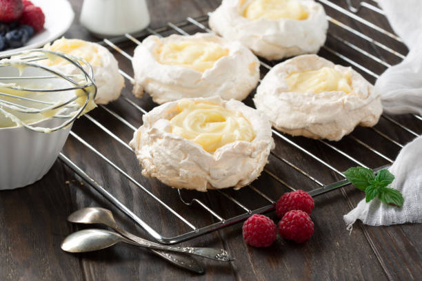 istock Pavlova cake with fresh summer berries on wooden table. 1317617831