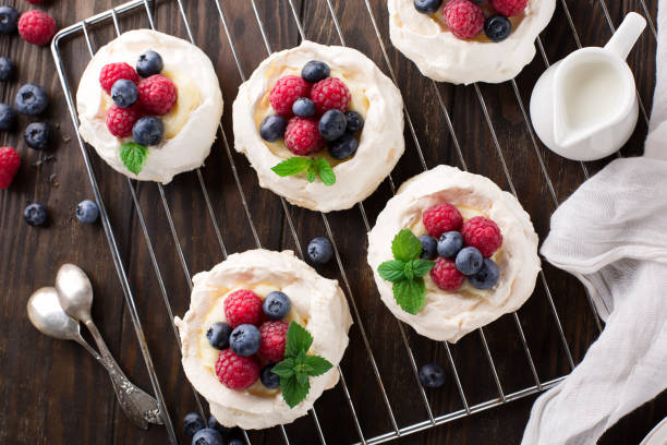 istock Pavlova cake with fresh summer berries on wooden table. 1317617837