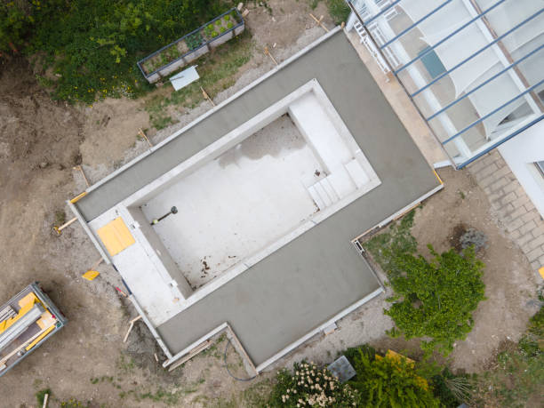 istock aerial drone flight pic of Swimming pool construction site from above 1317619285