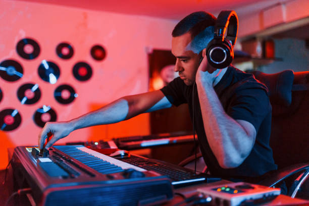 istock Professional sound engineer working and mixing music indoors in the studio 1317619619
