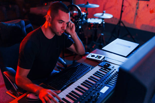 istock Professional sound engineer working and mixing music indoors in the studio 1317619662