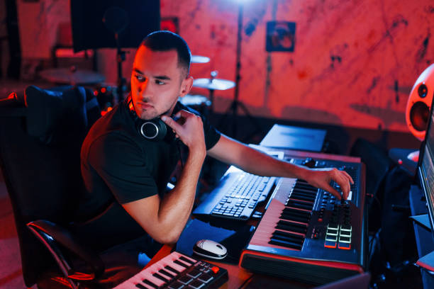 istock Professional sound engineer working and mixing music indoors in the studio 1317619737