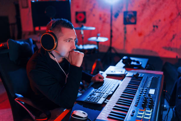 istock Young soung engineer working and mixing music indoors in the studio 1317619842