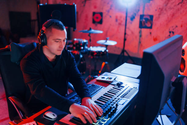 istock Young soung engineer working and mixing music indoors in the studio 1317620419
