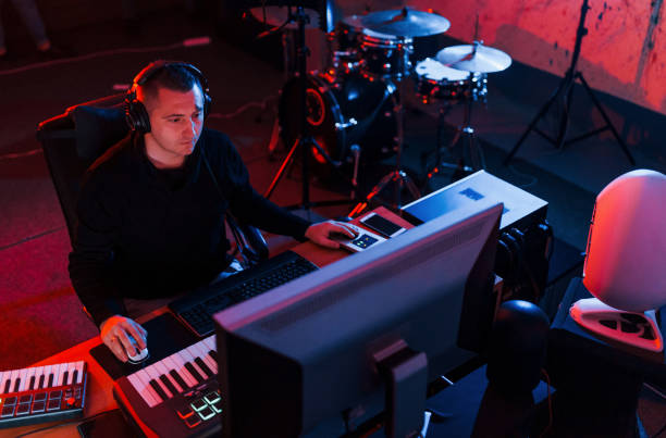 istock Young soung engineer working and mixing music indoors in the studio 1317620494