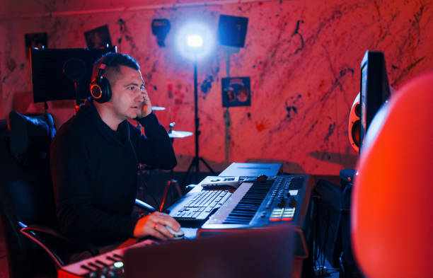 istock Young soung engineer working and mixing music indoors in the studio 1317620526