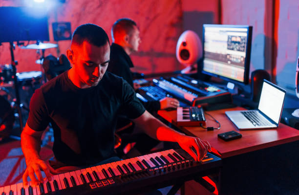 istock Sound engineer have recording session with piano player indoors in the studio 1317620645