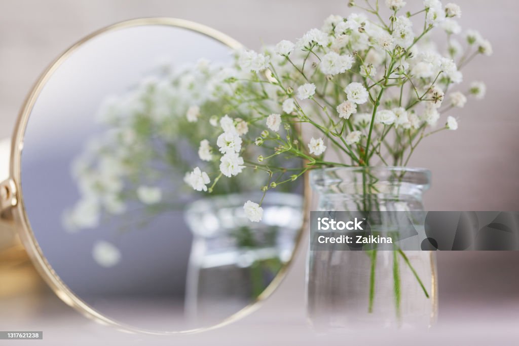 Rustic Baby"u2019s Breath Dried white gypsophila flowers and mirror on the table. Beautiful wedding decor ideas and decor interior. Rustic Baby"u2019s Breath Dried white gypsophila flowers and mirror on the table. Beautiful wedding decor ideas and room home decor interior. Flower Stock Photo