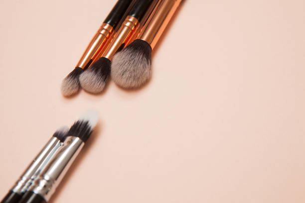 istock Various cosmetic brushes on pink background. Makeup brushes set for take care skin. 1317622222