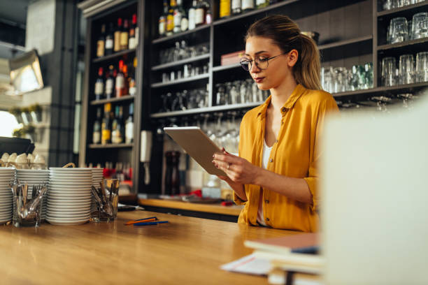istock Woman using technology to streamline daily coffee shop related tasks 1317622477