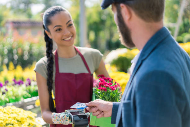 istock Man paying on POS terminal at the garden center 1317623537